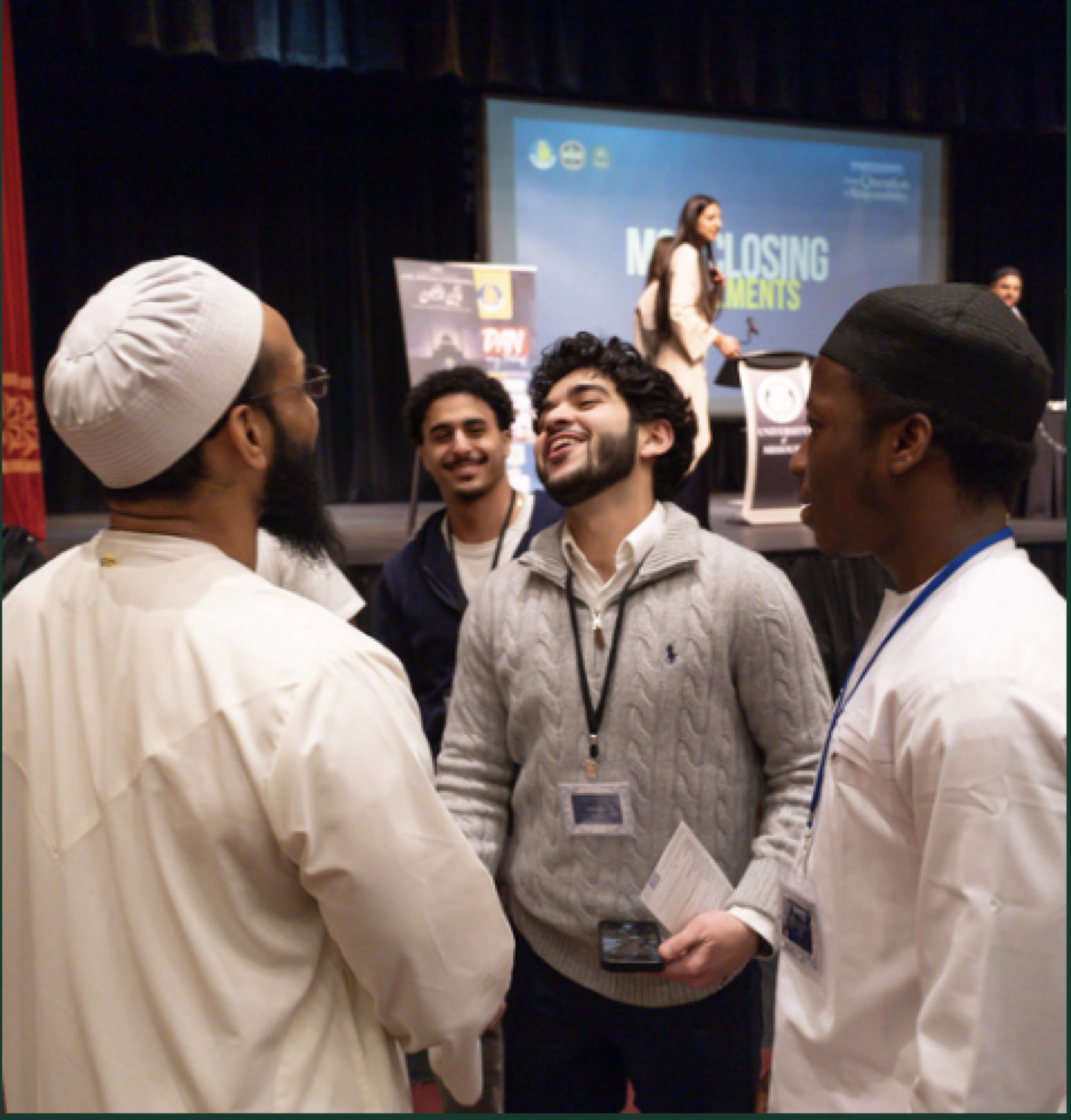 Brothers conversing at a Najm community event